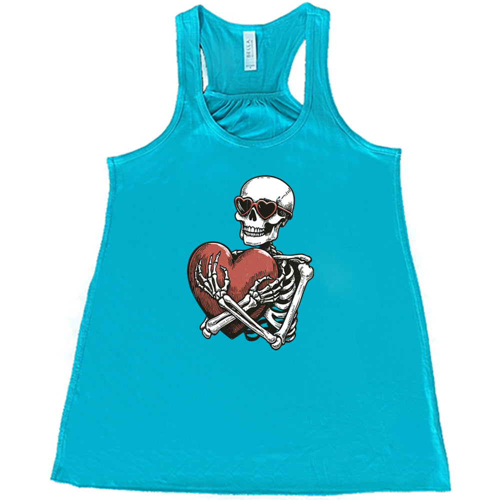 teal shirt with a skeleton hugging a heart graphic on it