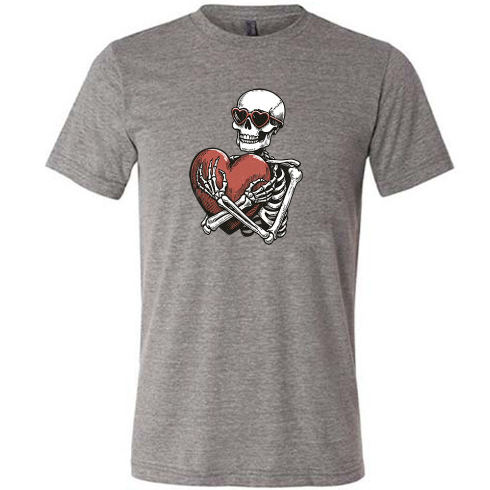 grey shirt with a skeleton hugging a heart graphic on it