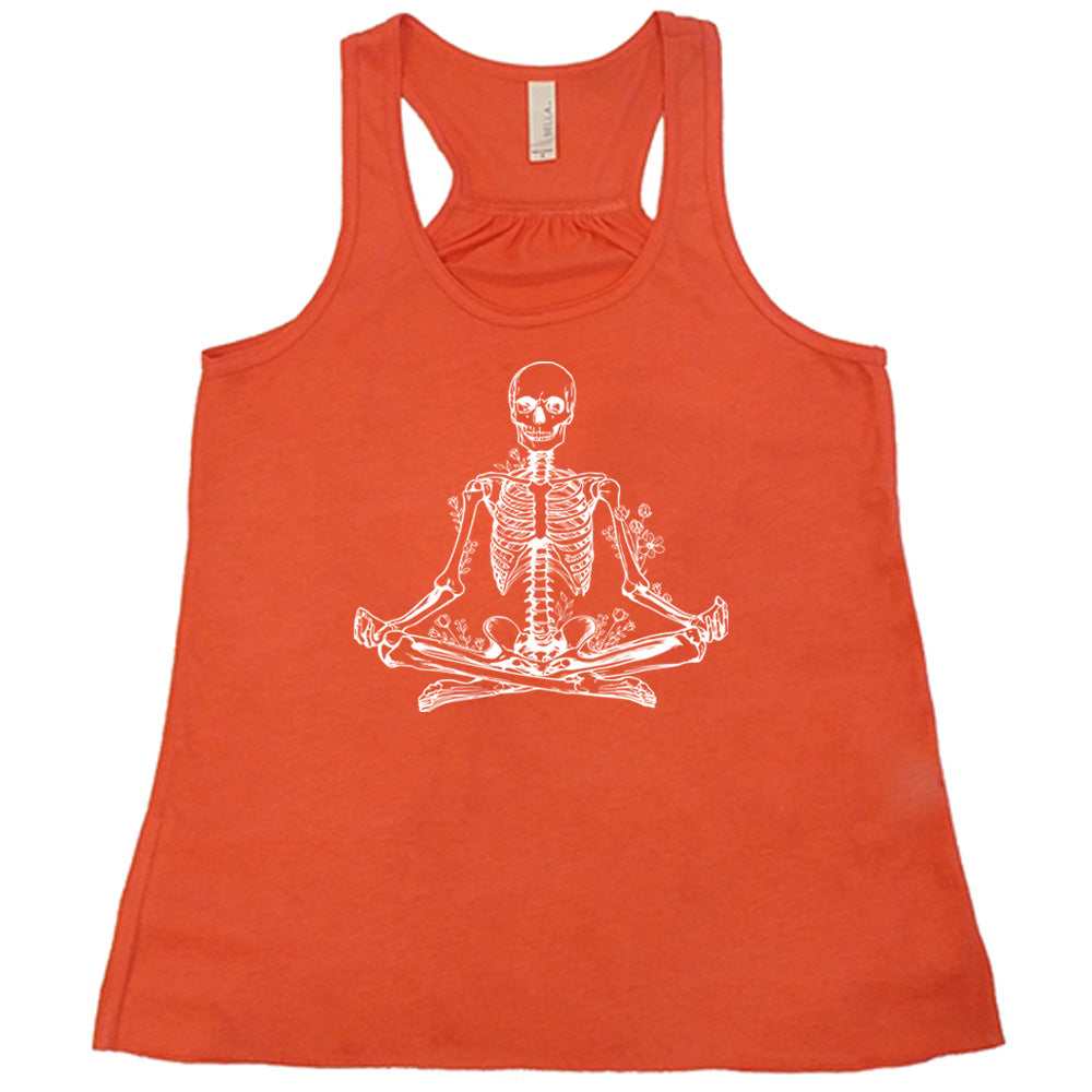 Coral flowy tank with a graphic of a skeleton doing a yoga pose, with some flowers growing out of different place on the body