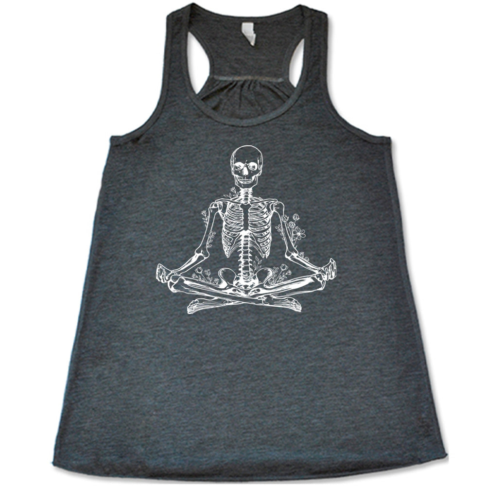 Grey flowy tank with a graphic of a skeleton doing a yoga pose, with some flowers growing out of different place on the body