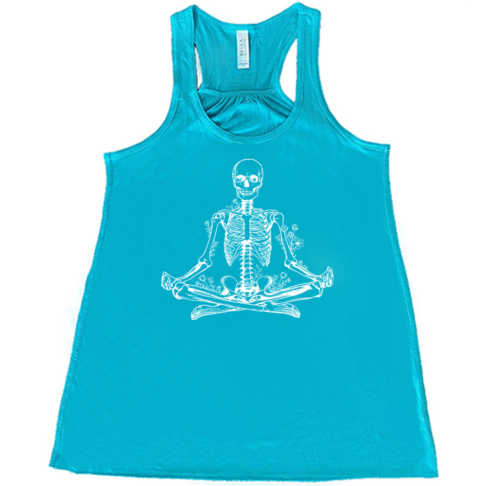 Teal flowy tank with a graphic of a skeleton doing a yoga pose, with some flowers growing out of different place on the body