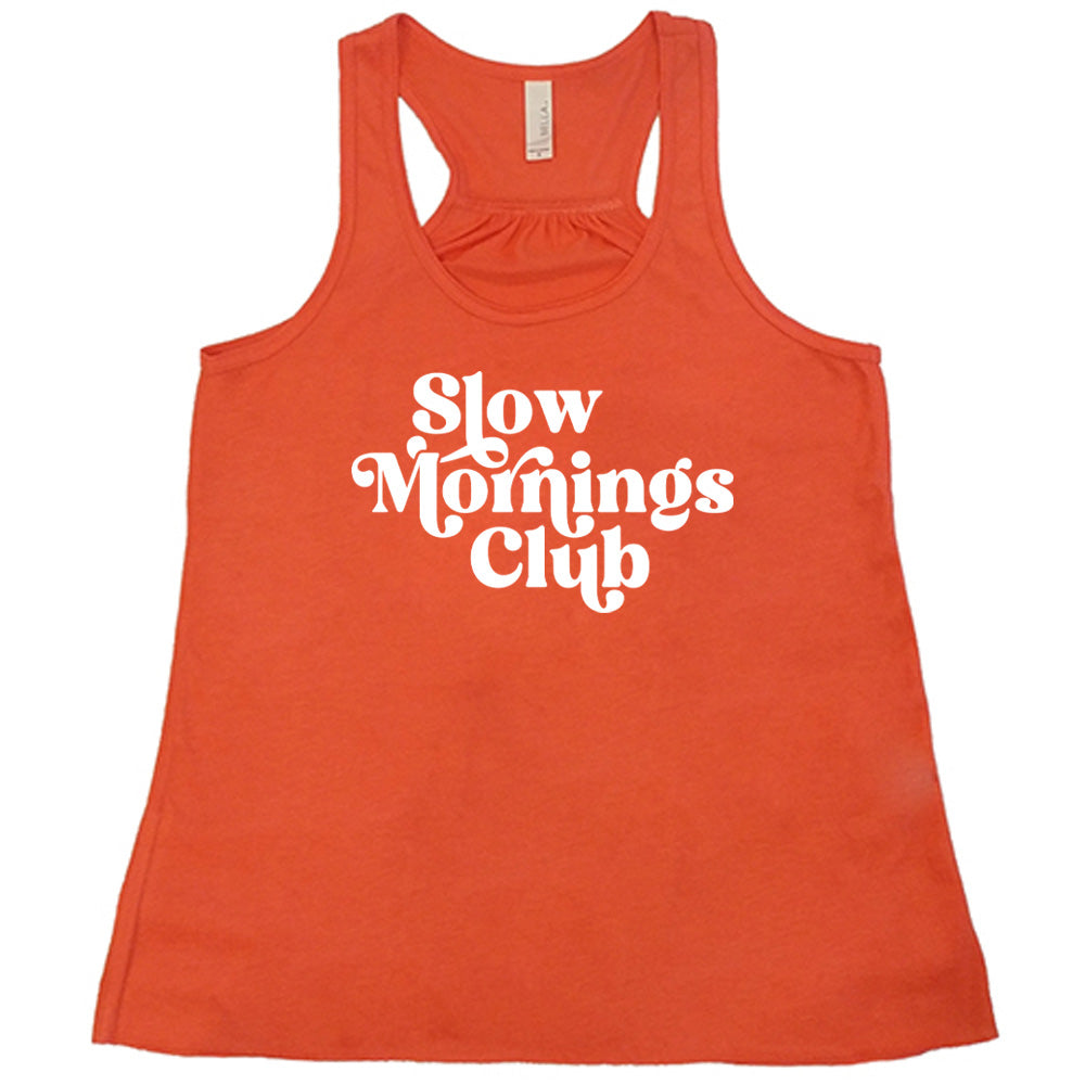 Coral colored flowy tank with a graphic on it that says "Slow Mornings Club"