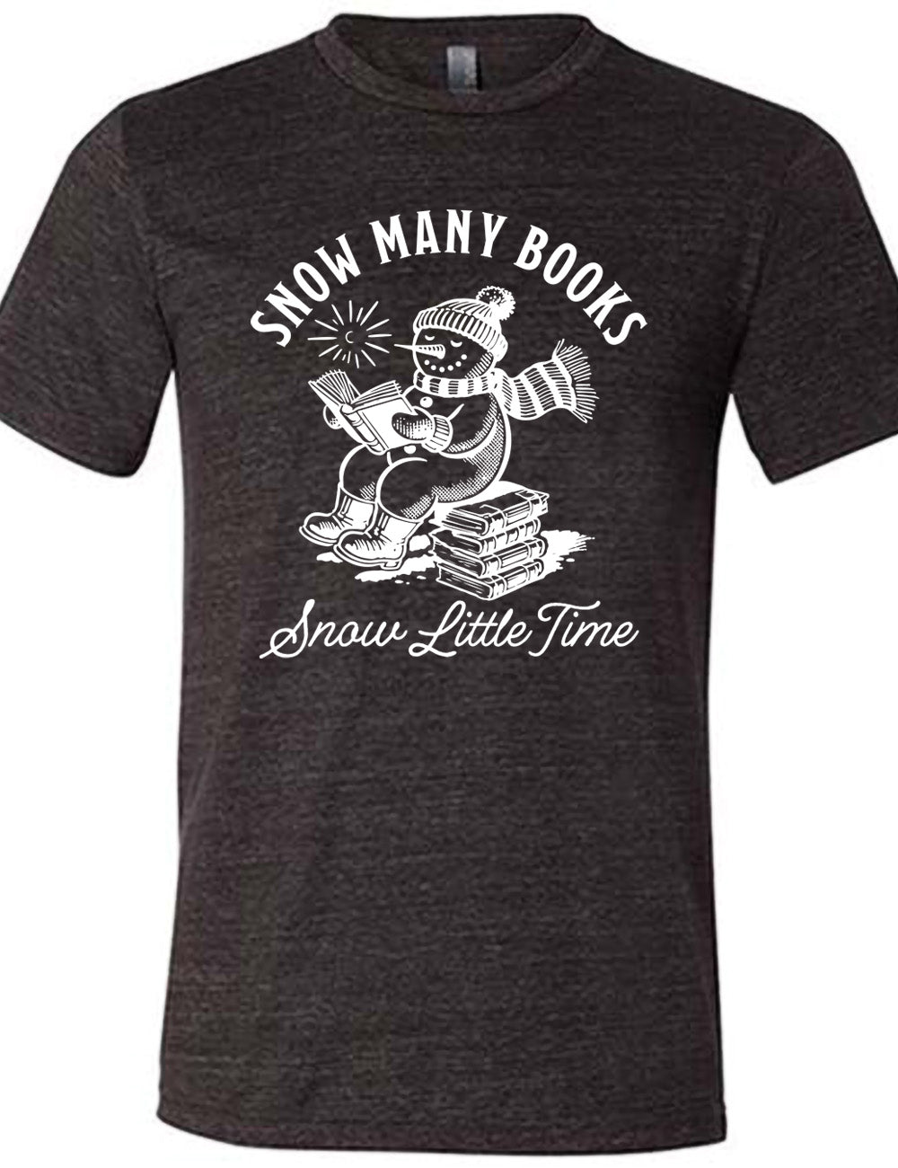 black unisex tee with the graphic of a happy snowman, wearing a snowsuit and boots, mittens, a hat, and book, reading a book while sitting on a stack of books, with a sun in the sky, and the words arching above saying "snow many books" and the words in a line of cursive below saying "snow little time"