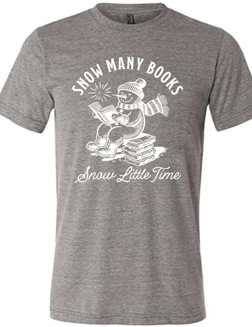 grey unisex tee with the graphic of a happy snowman, wearing a snowsuit and boots, mittens, a hat, and book, reading a book while sitting on a stack of books, with a sun in the sky, and the words arching above saying "snow many books" and the words in a line of cursive below saying "snow little time"