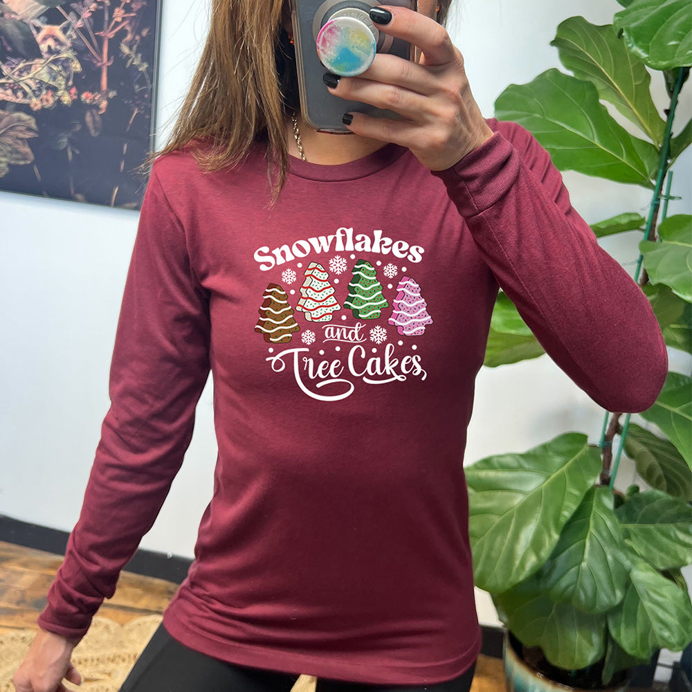 heather cardinal long sleeve shirt with the words "Snowflakes & Tree Cakes" on it and graphics matching those words