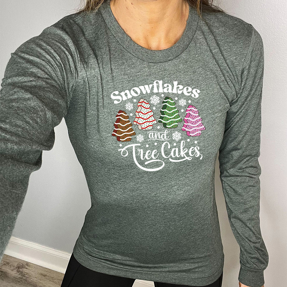 heather forest long sleeve shirt with the words "Snowflakes & Tree Cakes" on it and graphics matching those words