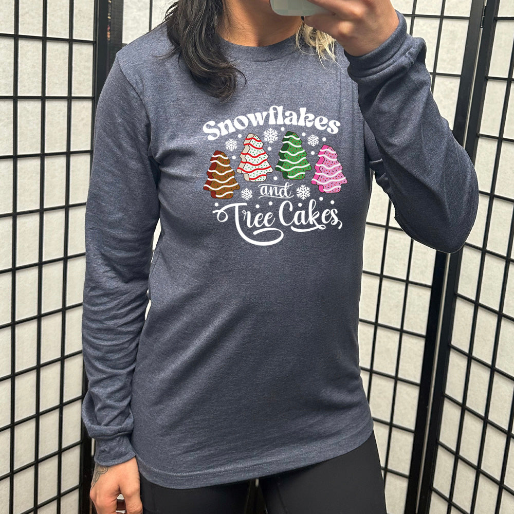 heather navy long sleeve shirt with the words "Snowflakes & Tree Cakes" on it and graphics matching those words