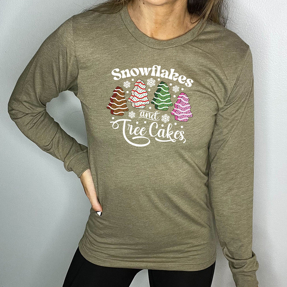 heather olive long sleeve shirt with the words "Snowflakes & Tree Cakes" on it and graphics matching those words