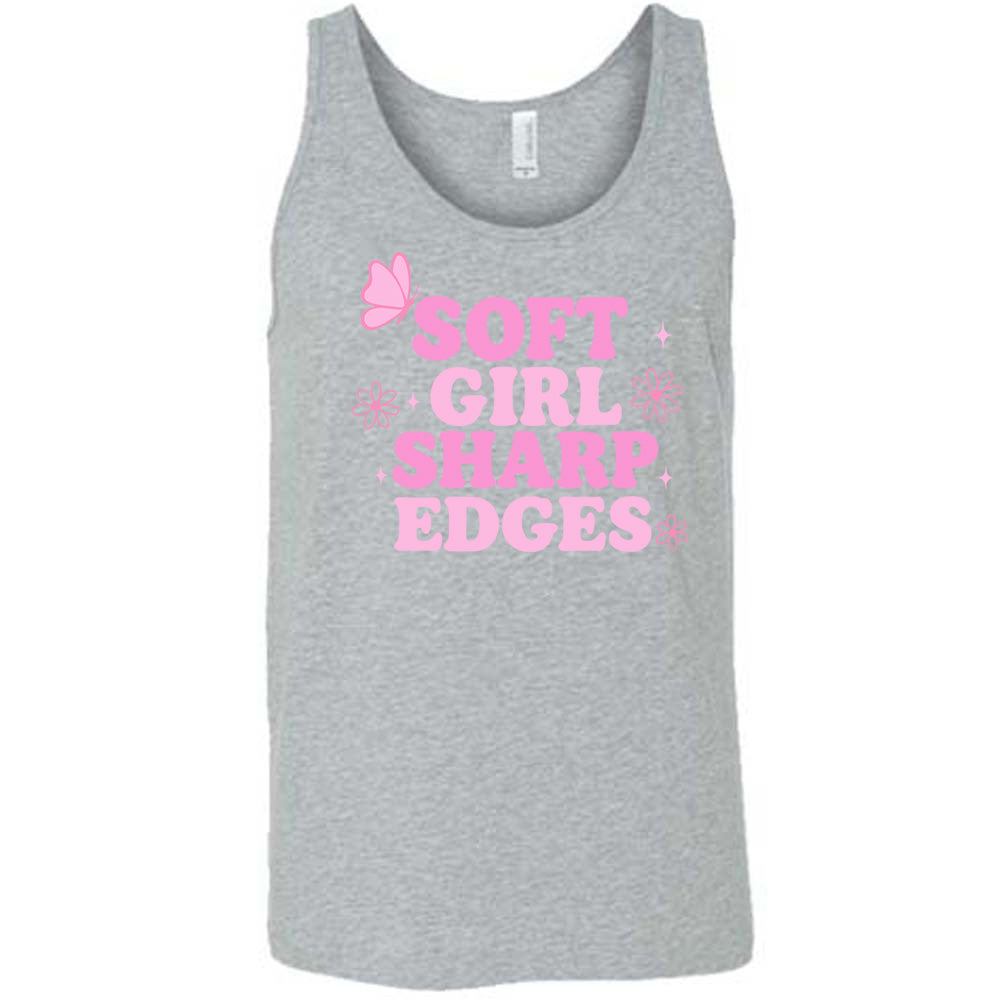 grey unisex tank with the words "soft girl sharp edges" in all caps, with graphics of a few little flowers and stars and one butterfly