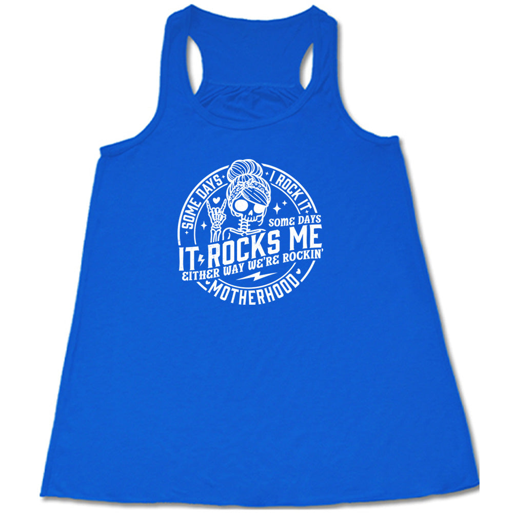 Blue colored flowy tank with a female skeleton graphic on it that says "Some Days I Rock It Some Days It Rocks Me"