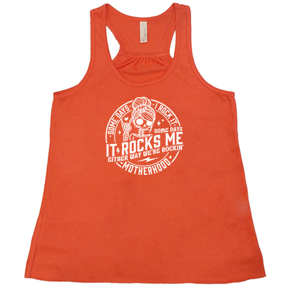 Coral colored flowy tank with a female skeleton graphic on it that says "Some Days I Rock It Some Days It Rocks Me"