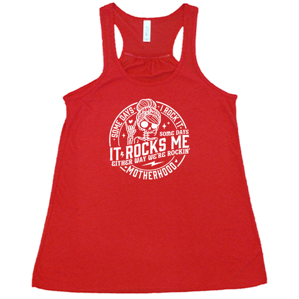Red colored flowy tank with a female skeleton graphic on it that says "Some Days I Rock It Some Days It Rocks Me"