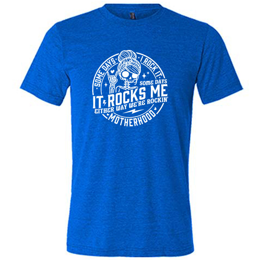 Blue colored shirt with a female skeleton graphic on it that says "Some Days I Rock It Some Days It Rocks Me"