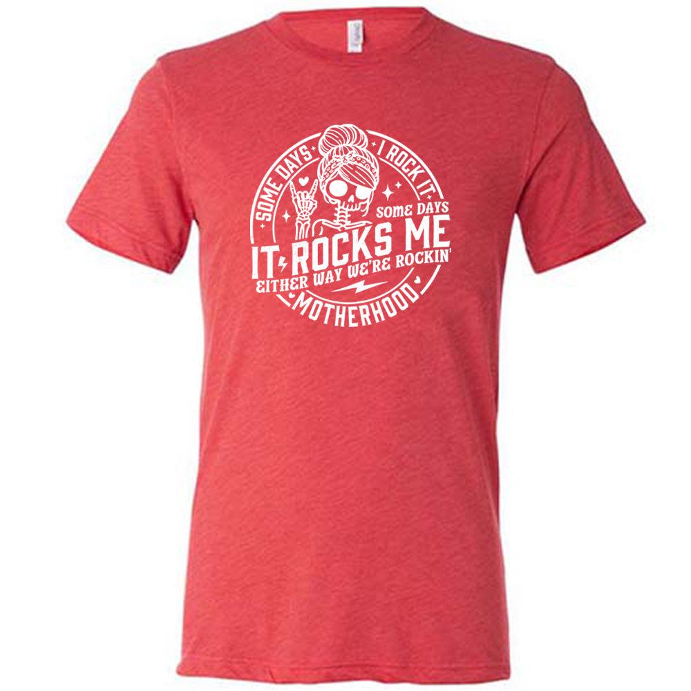 Red colored shirt with a female skeleton graphic on it that says "Some Days I Rock It Some Days It Rocks Me"