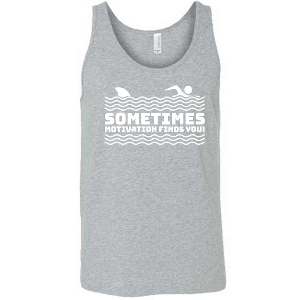 grey unisex tank with the words "sometimes motivation finds you!" in between the lined graphic of waves of the sea, and on top of the waves is the graphic of a figure swimming away from a fin in the water behind