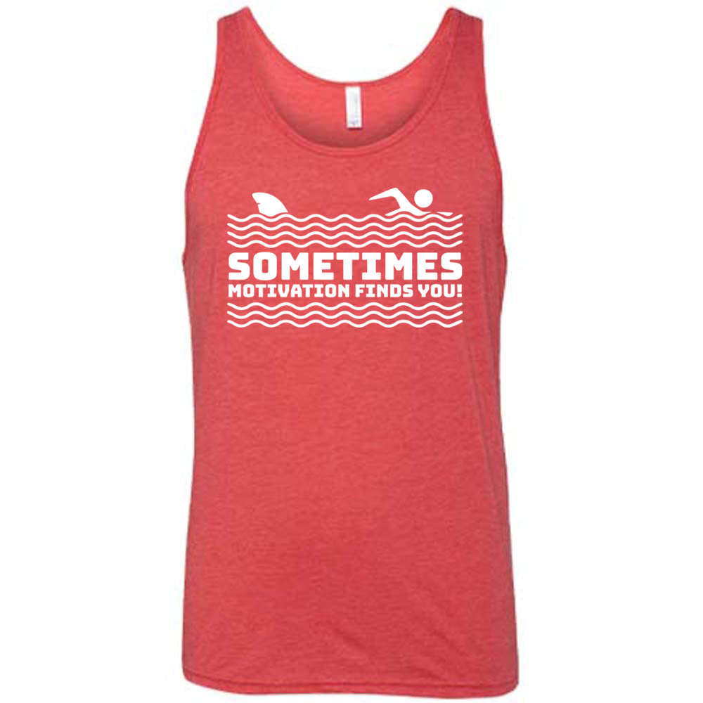 red unisex tank with the words "sometimes motivation finds you!" in between the lined graphic of waves of the sea, and on top of the waves is the graphic of a figure swimming away from a fin in the water behind