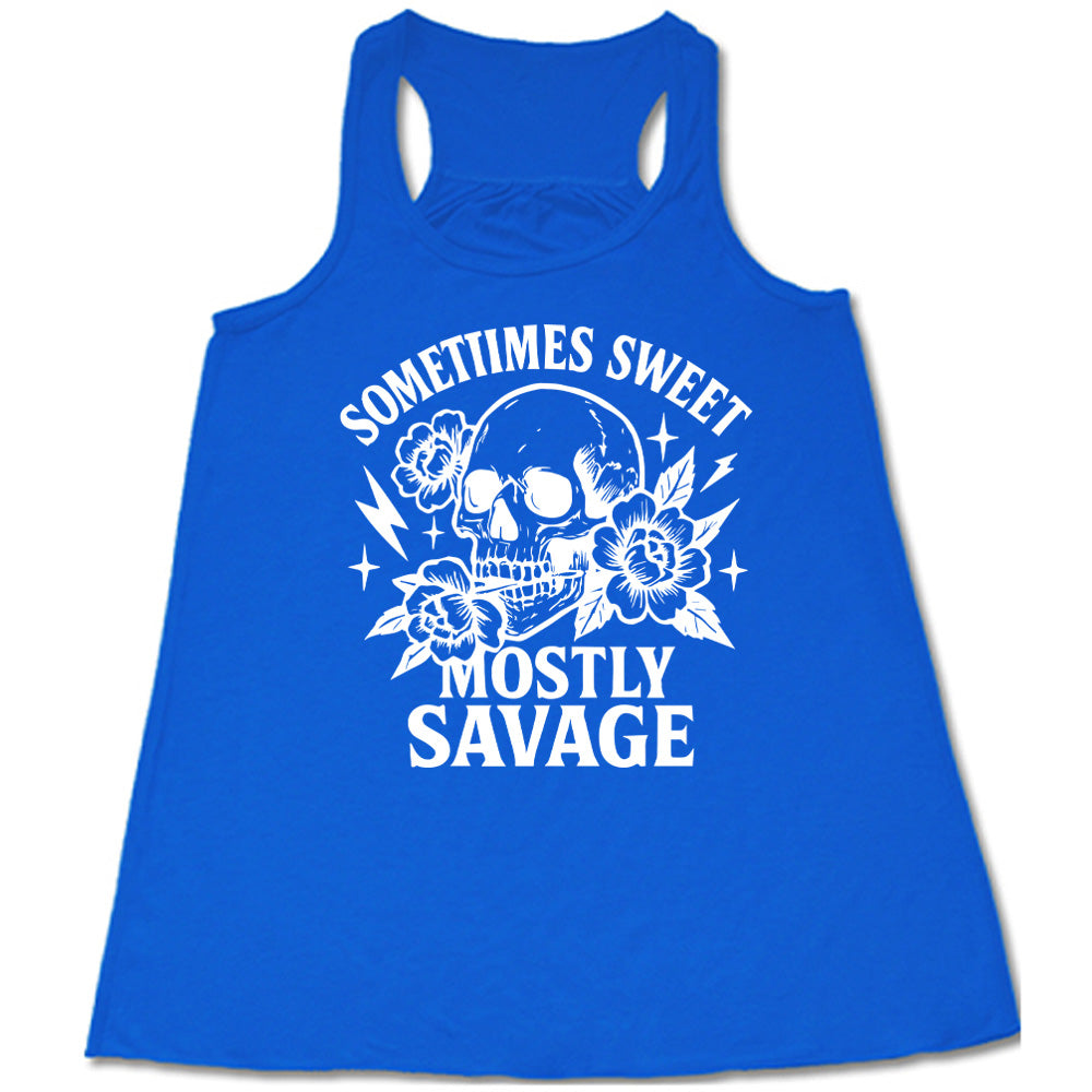 blue flowy tank with the words "sometimes sweet mostly savage on it with the graphic of a skull holding a flower between its teeth, with a couple flowers and a few stars and lightening bolts around it