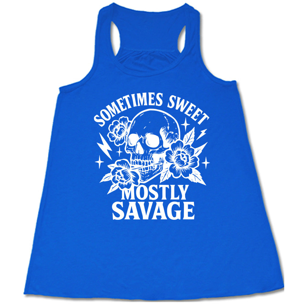blue flowy tank with the words "sometimes sweet mostly savage on it with the graphic of a skull holding a flower between its teeth, with a couple flowers and a few stars and lightening bolts around it