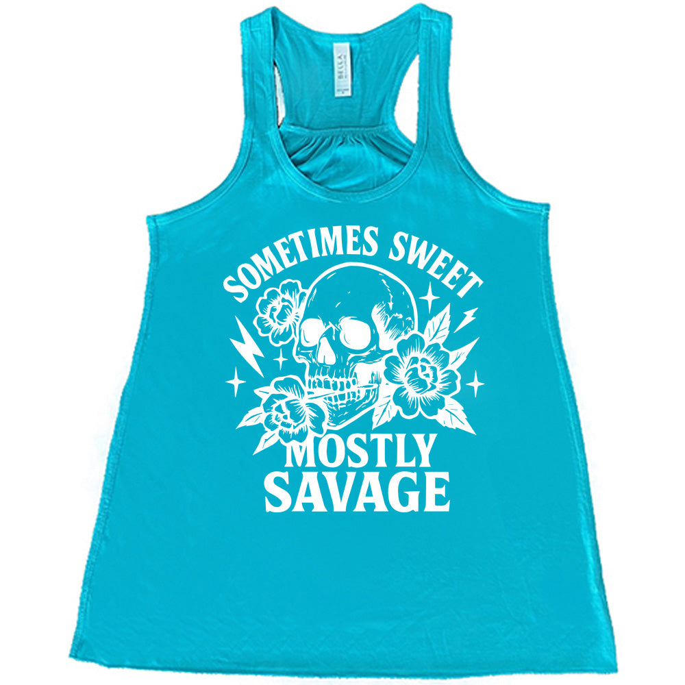 teal flowy tank with the words "sometimes sweet mostly savage on it with the graphic of a skull holding a flower between its teeth, with a couple flowers and a few stars and lightening bolts around it