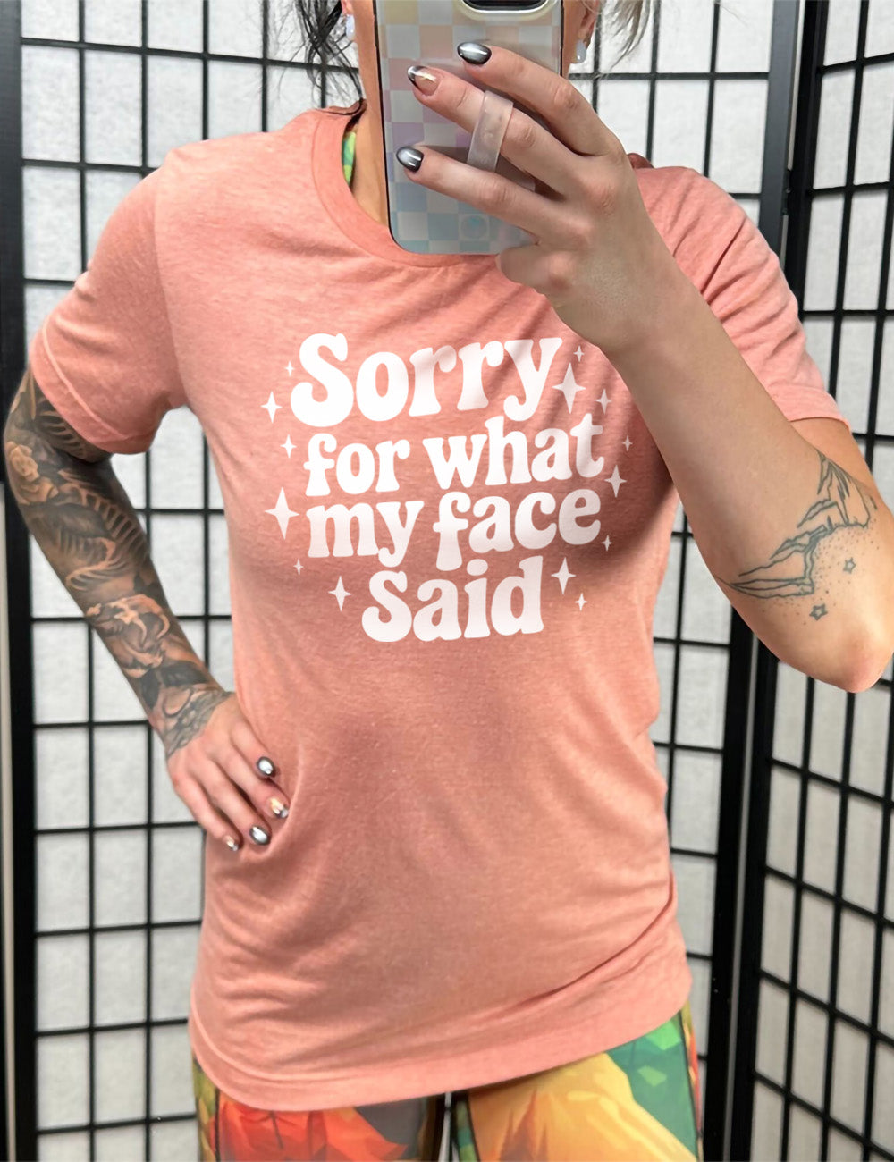 sunset unisex tee with the words, surrounded by stars, saying " sorry for what my face said"