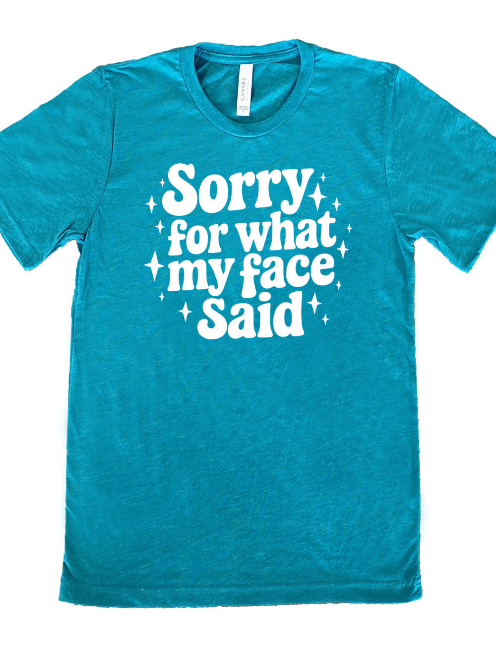 teal unisex tee with the words, surrounded by stars, saying " sorry for what my face said"