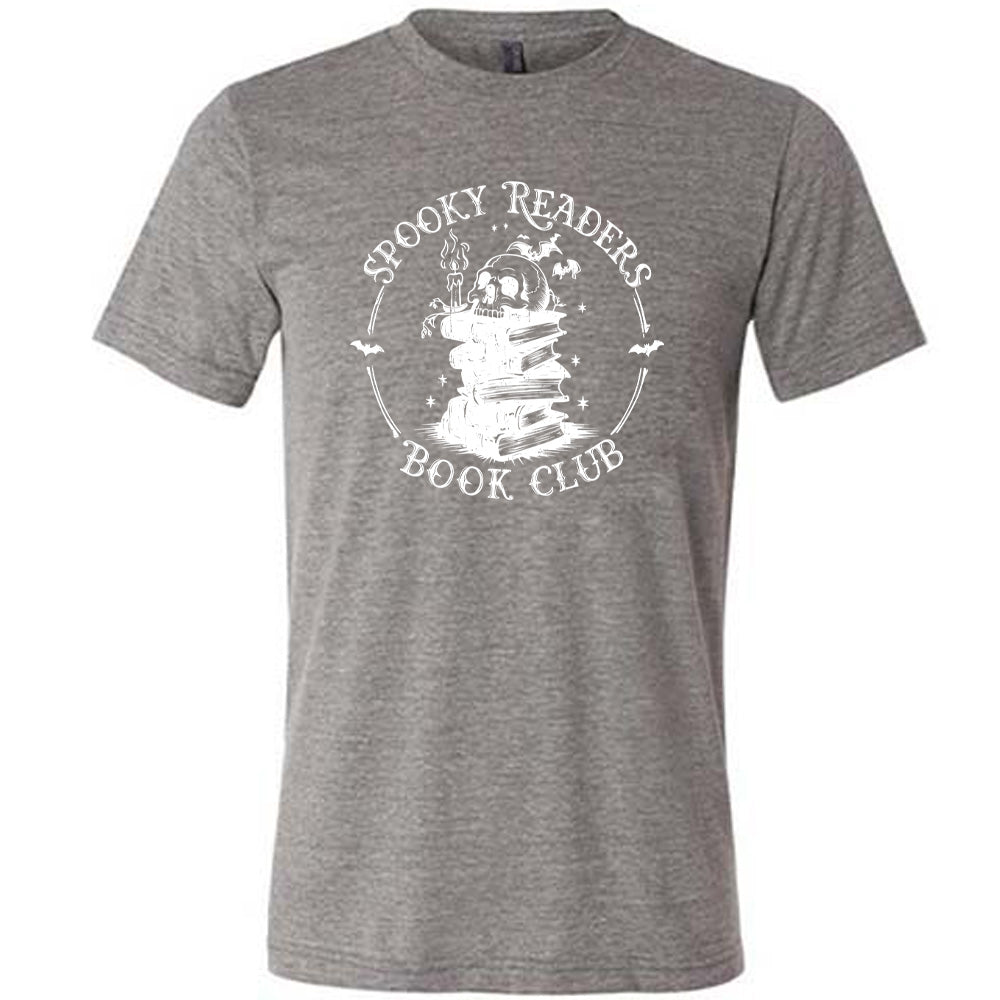 Grey colored shirt with skull on a stack of books graphic on it that says "Spooky Readers Book Club"