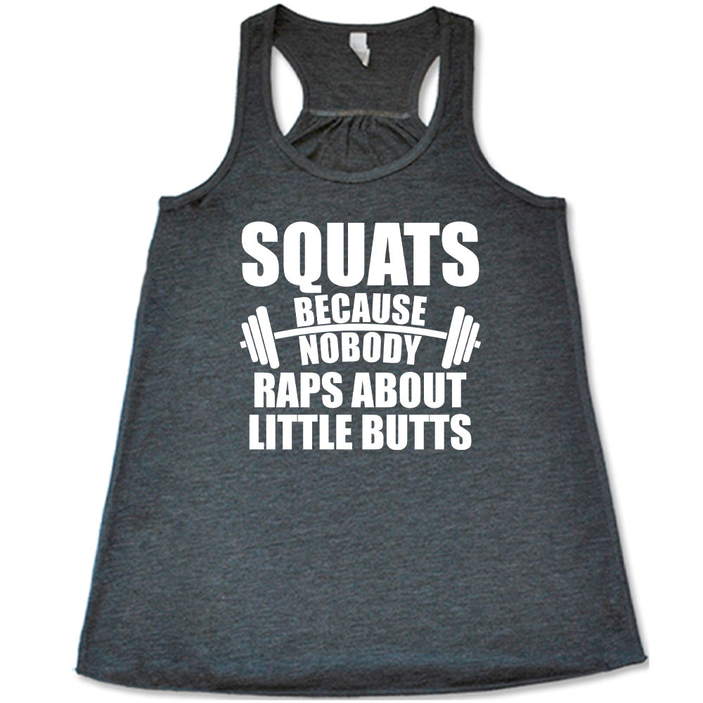 grey flowy tank with the words "squats because nobody raps about little butts" in all caps with a graphic of a barbell between the words "because" and "nobody"