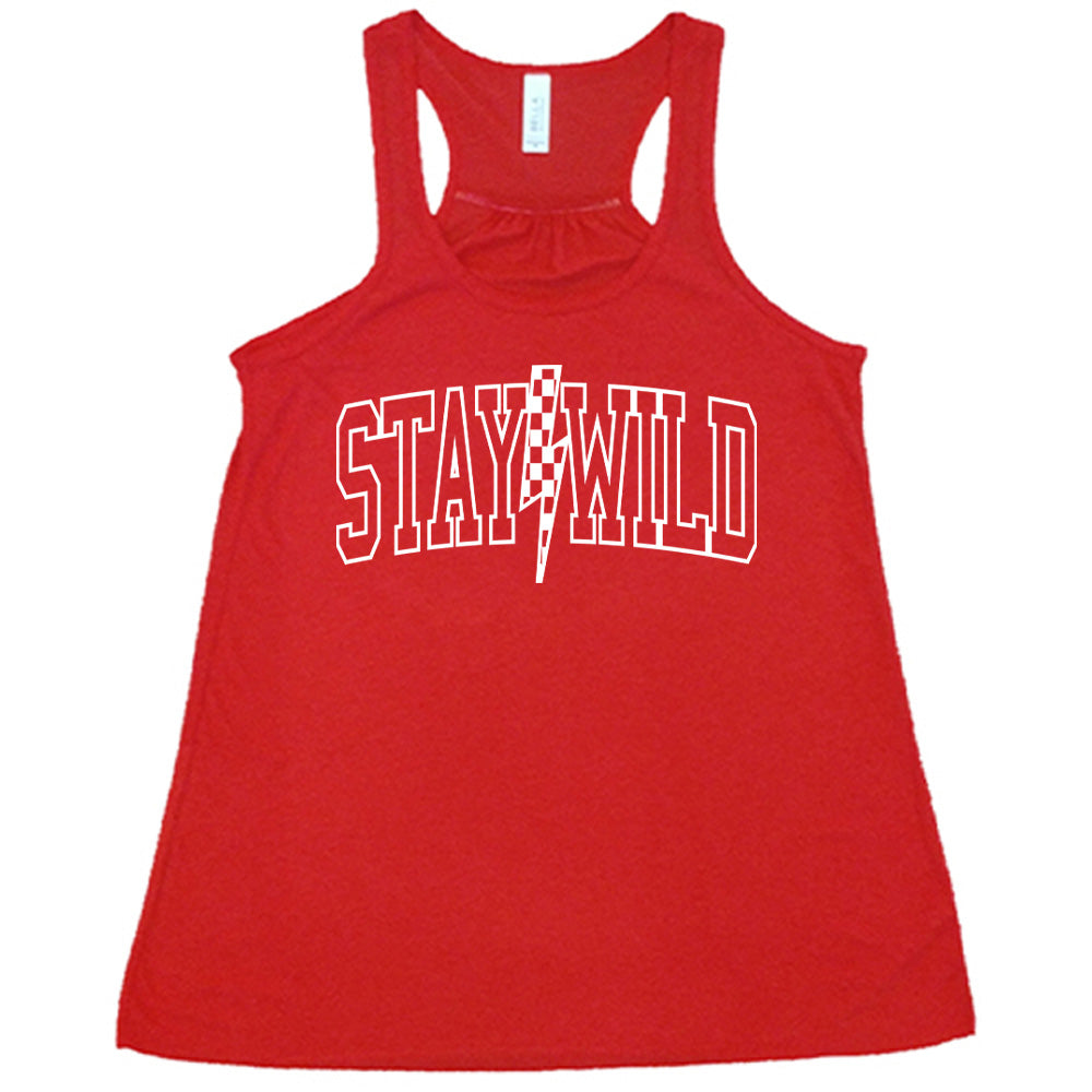 Red colored flowy tank with a checkered lightning strike graphic on it that says "Stay Wild"