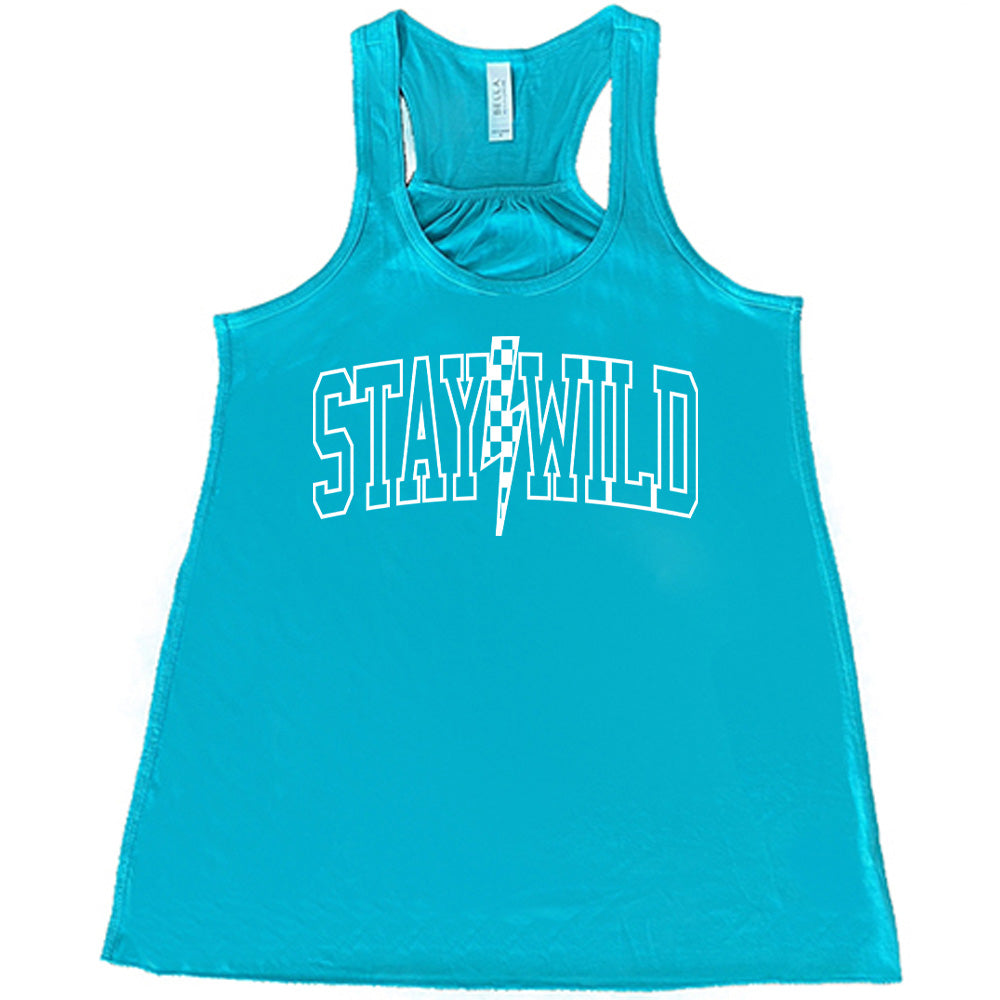 Teal colored flowy tank with a checkered lightning strike graphic on it that says "Stay Wild"