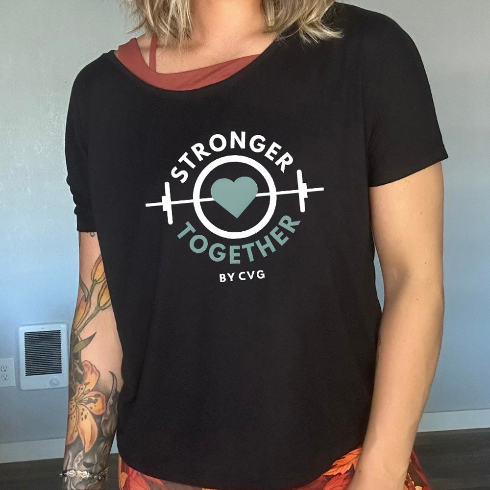Person wearing a black t-shirt with 'Stronger Together by CVG' design on it