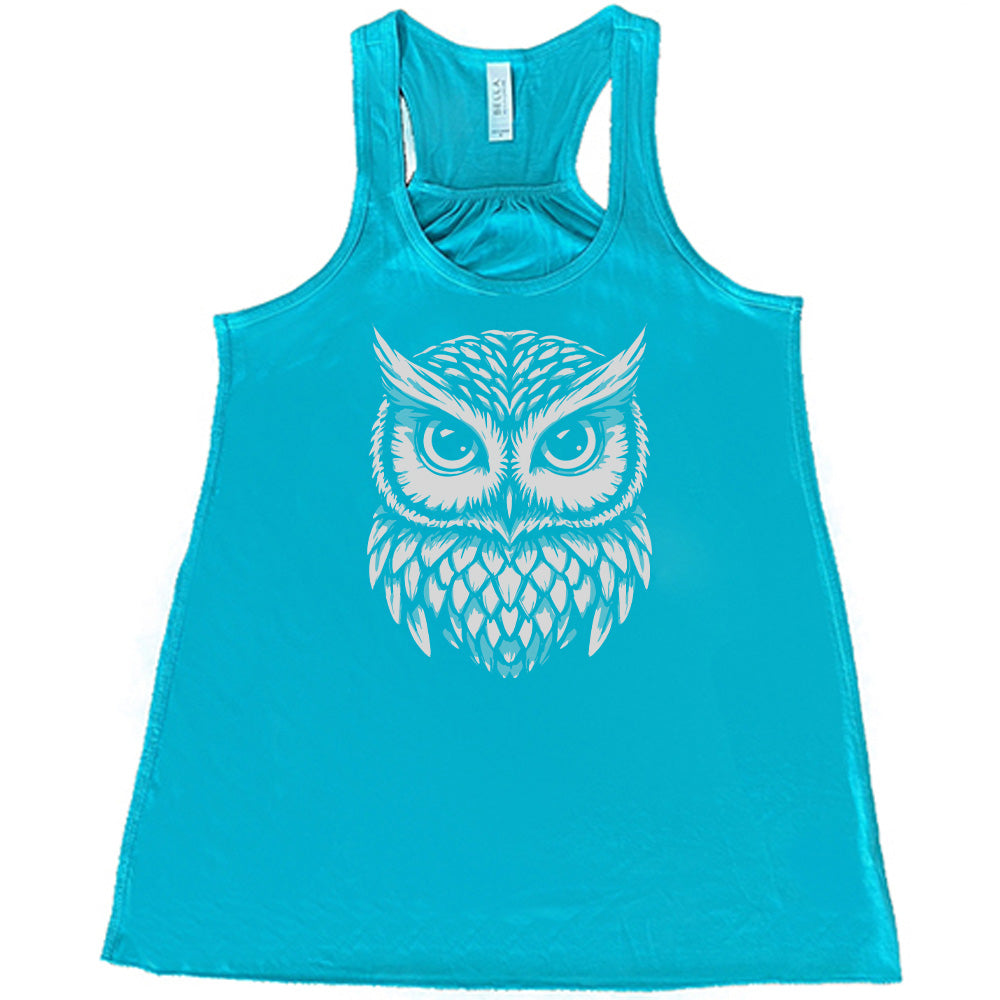 Teal colored flowy tank with stylized owl graphic on it