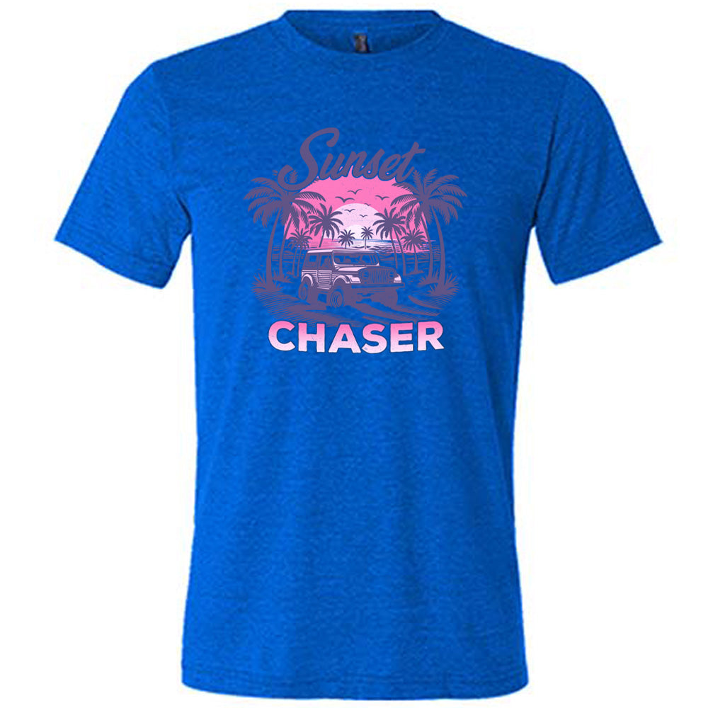 Blue colored shirt with a vehicle on the beach graphic on it that says "Sunset Chaser"