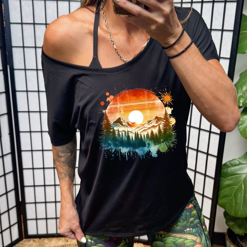 shirt with a sunset-mountain landscape graphic on it