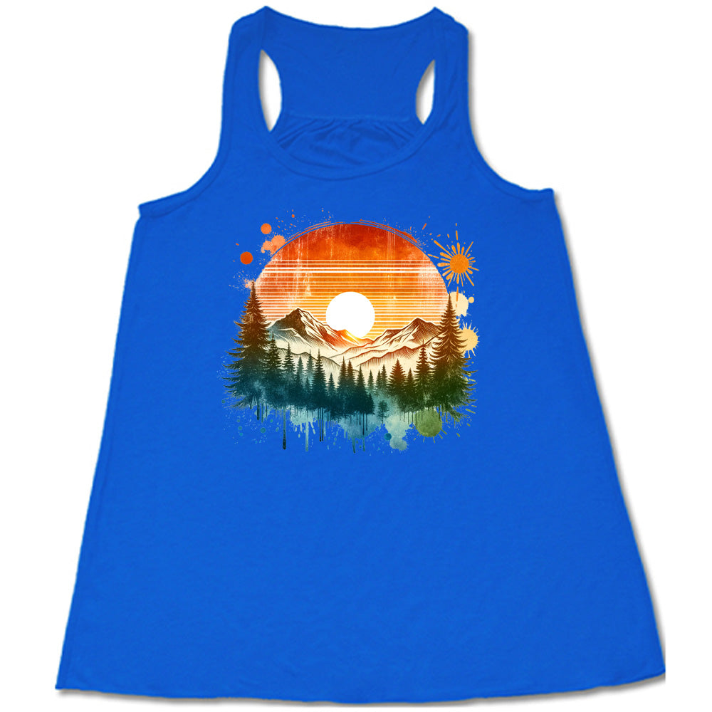 Blue colored flowy tank with a sunset-mountain landscape graphic on it