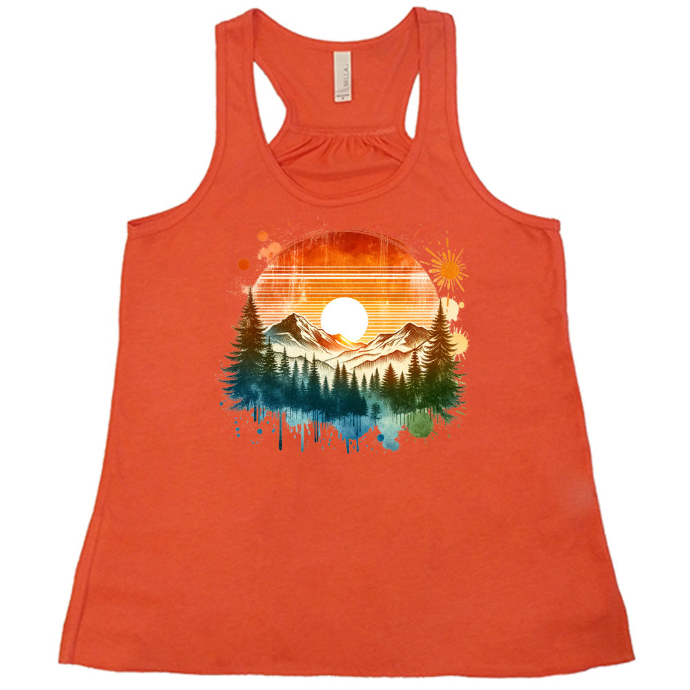 Coral colored flowy tank with a sunset-mountain landscape graphic on it