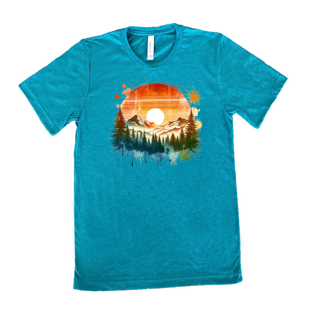 Teal colored shirt with a sunset-mountain landscape graphic on it