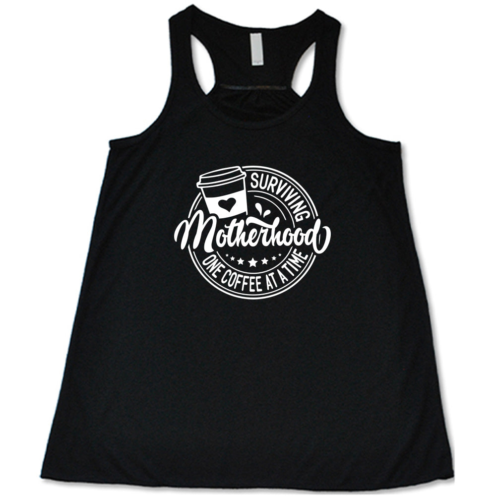 Black colored flowy tank with a coffee cup graphic on it that says "Surviving Motherhood One Coffee at a Time"