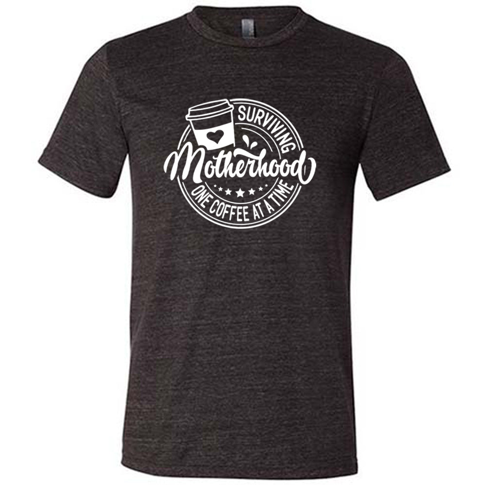 Black colored shirt with a coffee cup graphic on it that says "Surviving Motherhood One Coffee at a Time"