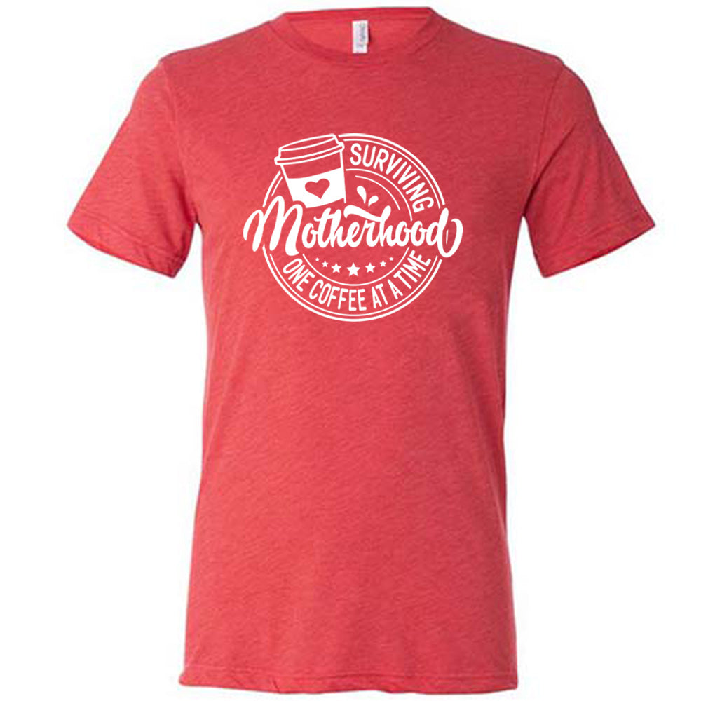 Red colored shirt with a coffee cup graphic on it that says "Surviving Motherhood One Coffee at a Time"