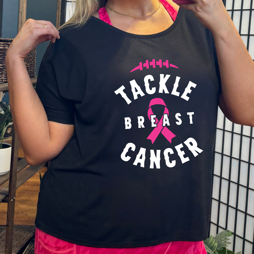Person wearing a black t-shirt with 'Tackle Breast Cancer' text and pink ribbon design