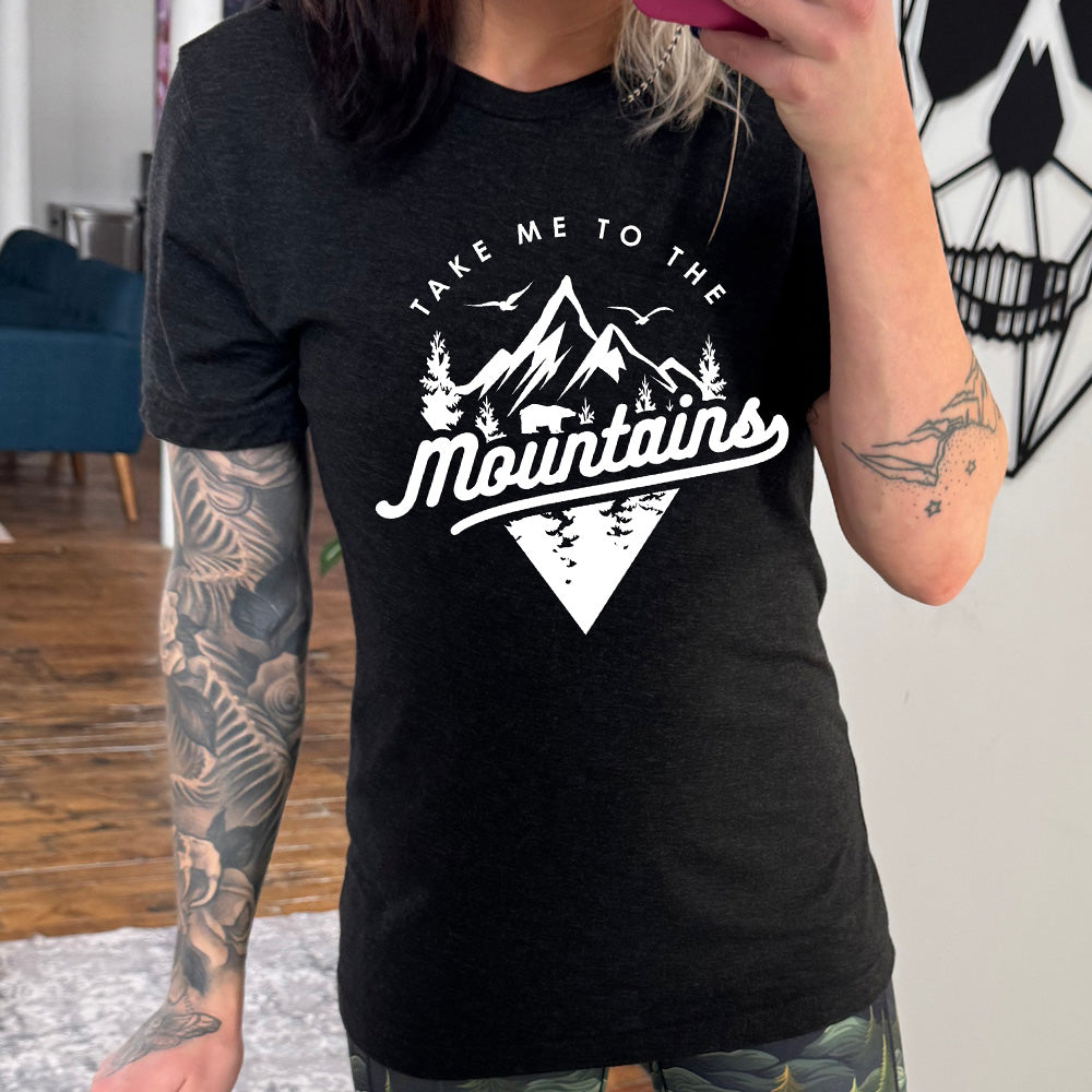 Black colored shirt with a mountains graphic on it that says "Take Me To The Mountains"