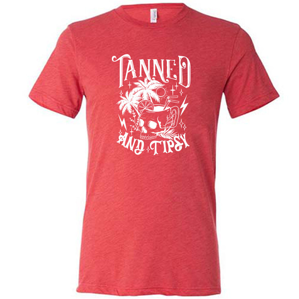Red colored shirt with a drink inside a skull cup graphic on it that says "Tanned and Tipsy"