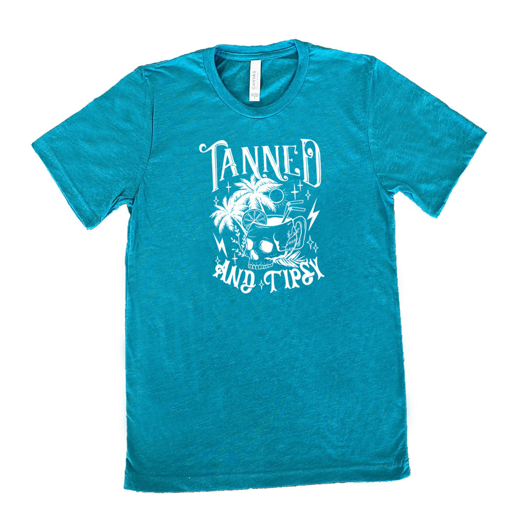 Teal colored shirt with a drink inside a skull cup graphic on it that says "Tanned and Tipsy"