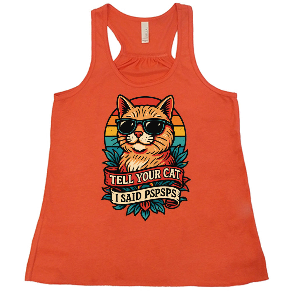 coral racerback tank with the large graphic of a cat head and torso, wearing sunglasses, with a colorful background, and two banners below it with the words "tell your cat I said pspsps" on them