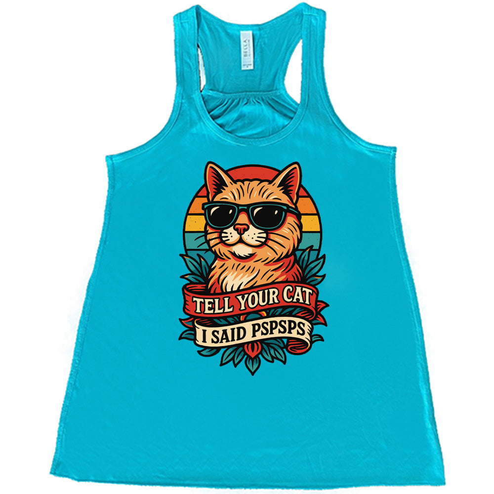 teal racerback tank with the large graphic of a cat head and torso, wearing sunglasses, with a colorful background, and two banners below it with the words "tell your cat I said pspsps" on them