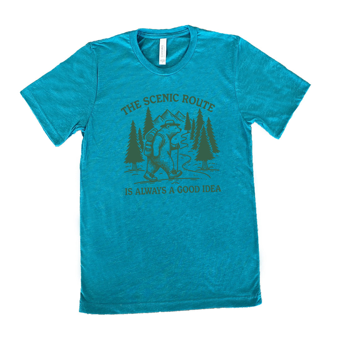 teal unisex tee with the words "the scenic route is always a good idea" with a bear hiking on a trail through the woods
