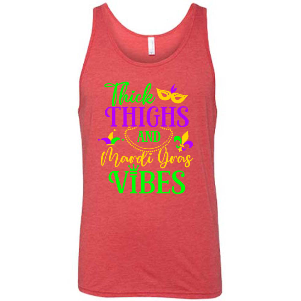 red unisex tank with the words "thick thighs and mardi gras vibes" on it in varying font, with small graphics of mardi gras beads, fleur de lis, a joker hat and a mask
