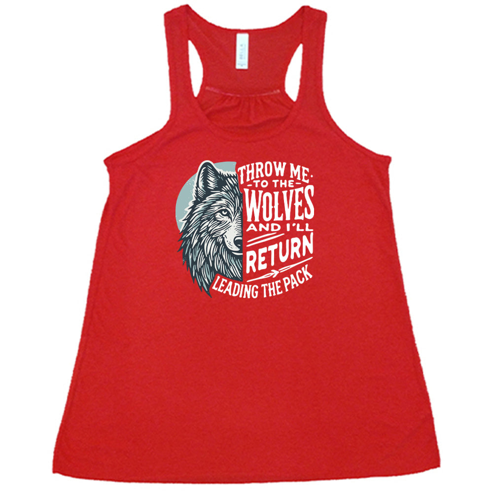 Red colored flowy tank with a wolf face graphic on it that says "Throw Me To The Wolves And I'll Return Leading the Pack"