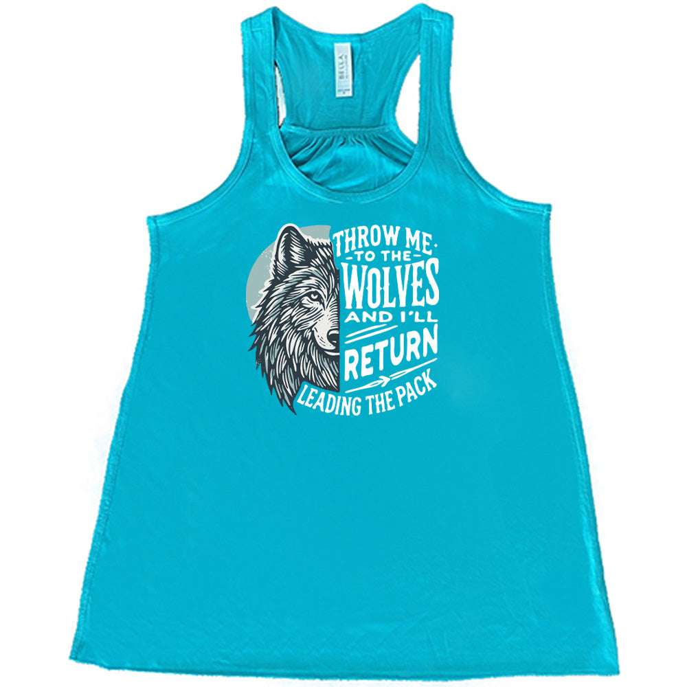 Teal colored flowy tank with a wolf face graphic on it that says "Throw Me To The Wolves And I'll Return Leading the Pack"
