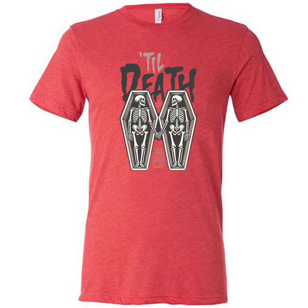 red unisex tee with the words "'til death" on it, with graphics of two skeletons, both in their own coffins, holding hands in the middle